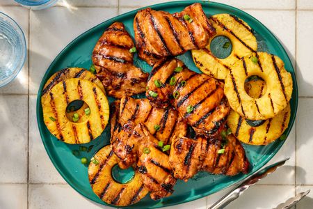 Grilled chicken and pineapple slices on a platter