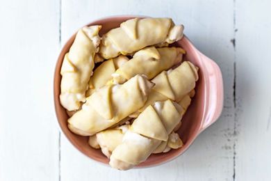 Overhead view of Butterhorn Cookies Filled with Walnut Meringue in a pink bowl.