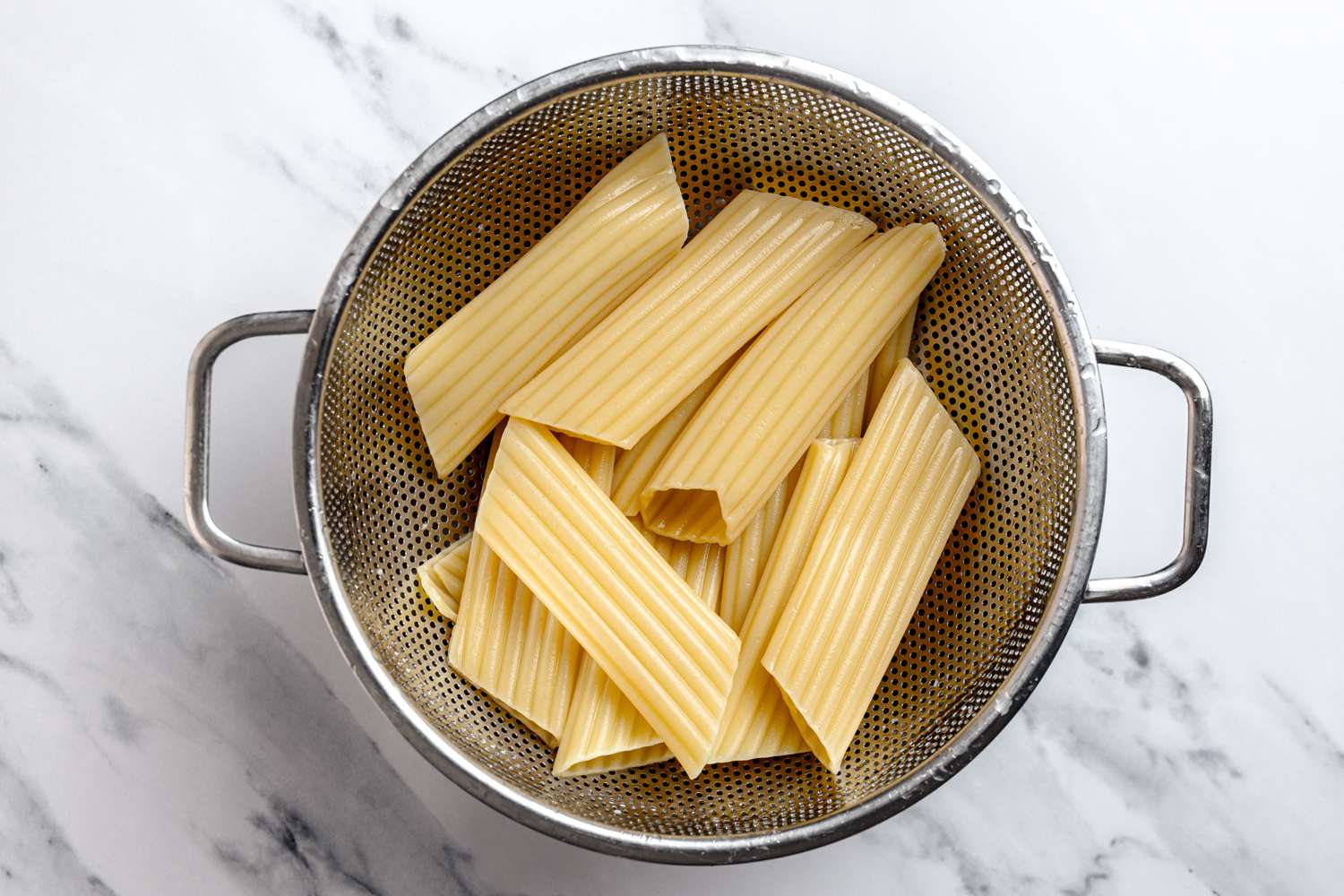 Cooked Manicotti Strained Over a Bowl Using a Colander for Manicotti Recipe