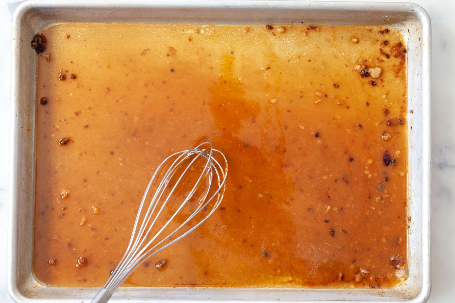 Whisking the dripping from a turkey breast recipe.