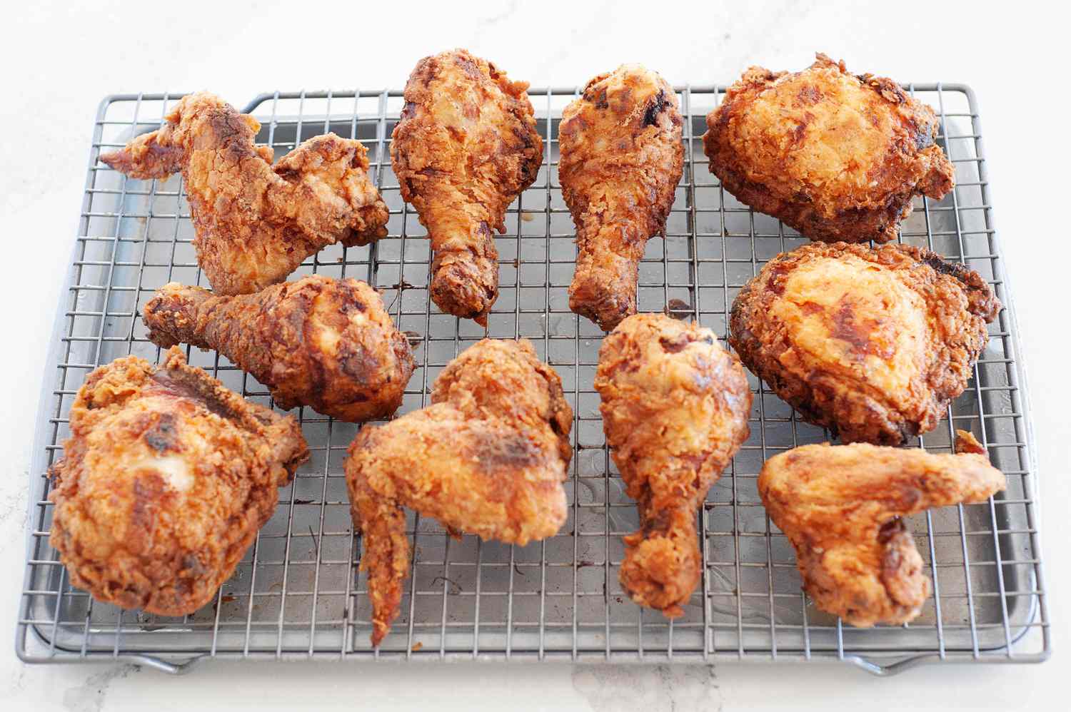 The buttermilk fried chicken cooling on a rack.