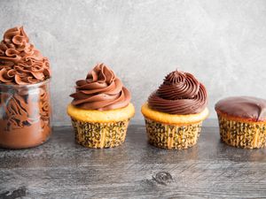 Side view of different ways to decorate cupcakes using the perfect chocolate ganache recipe
