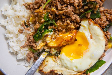 close up of a bowl of Beef Krapow bowl with a fried egg