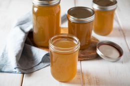 Mason jars filled with beef stock.