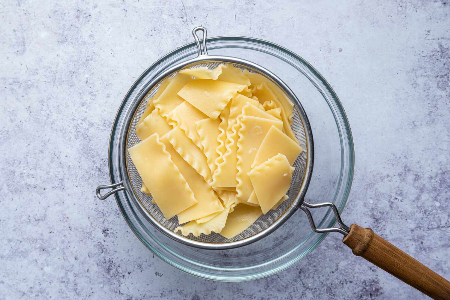 Cooked Lasagna Noodles in a Colander Over a Bowl for Lasagna Soup Recipe