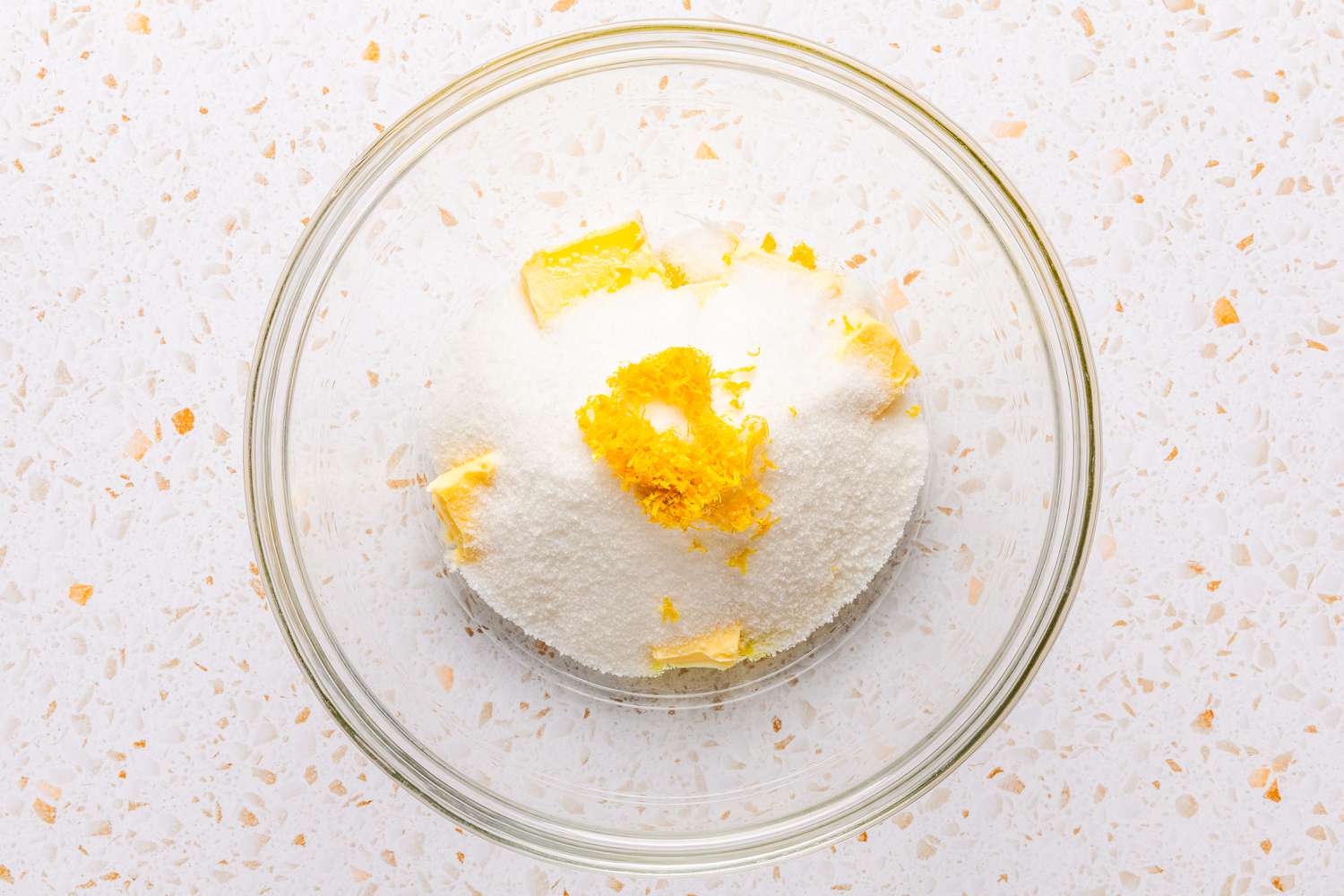 sugar, butter, and lemon zest in a bowl for ciambellone recipe