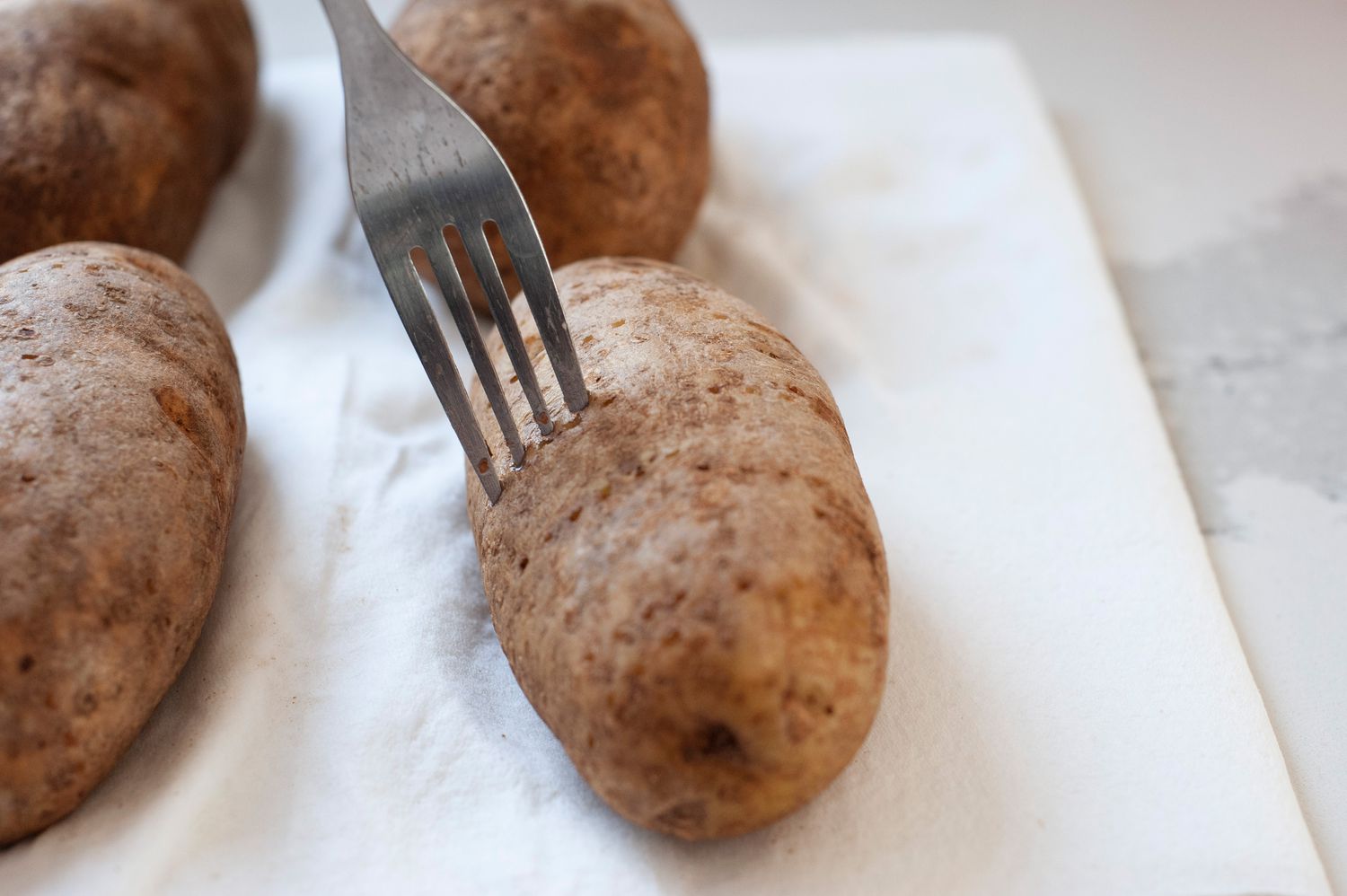 Holes Poked into Potatoes for Air Fryer Baked Potatoes Recipe