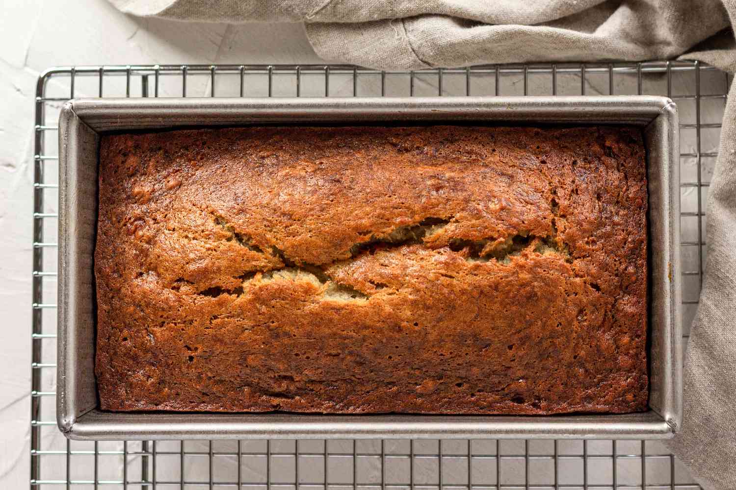 Baked banana bread in a loaf pan.