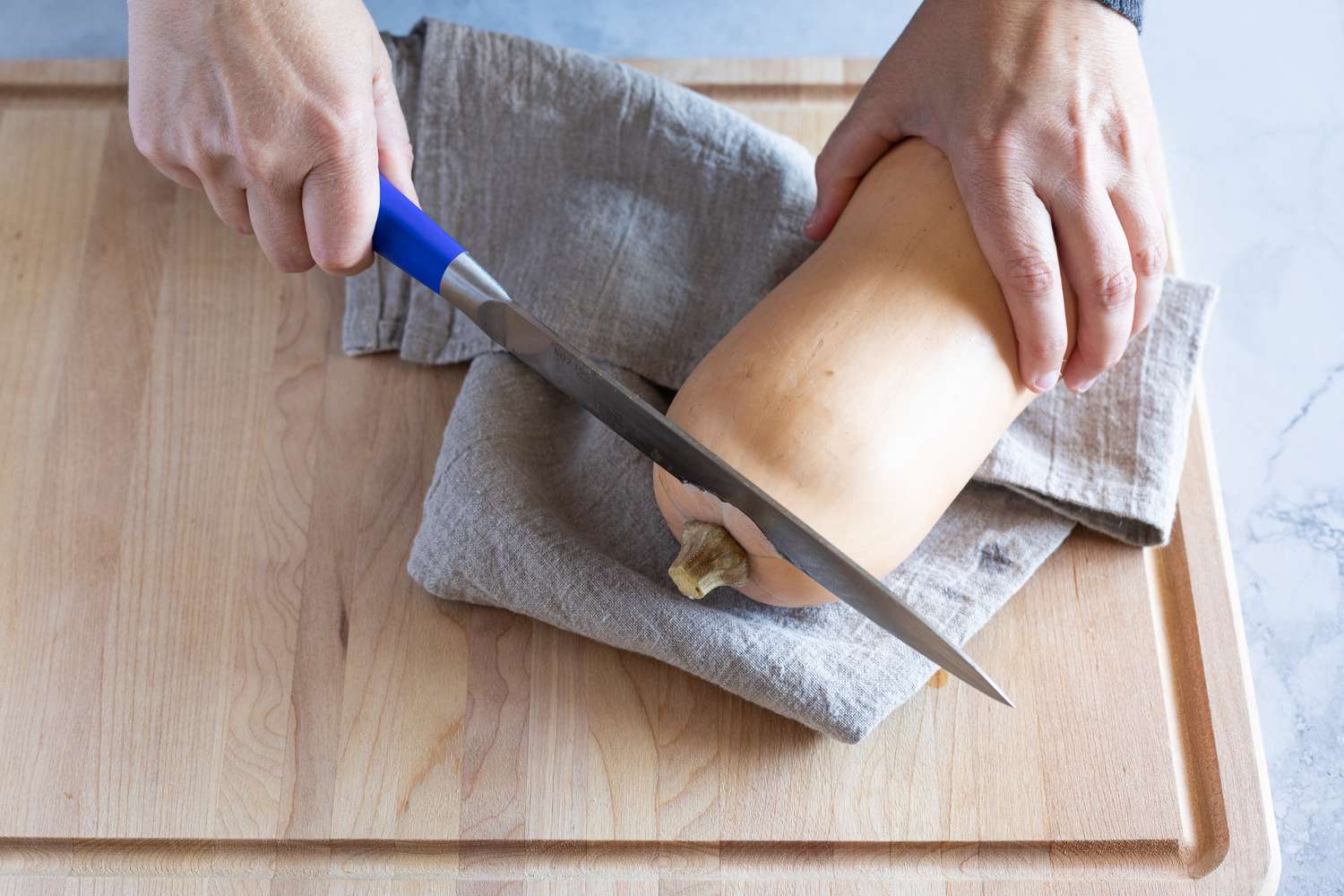 Trimming the end of a butternut squash