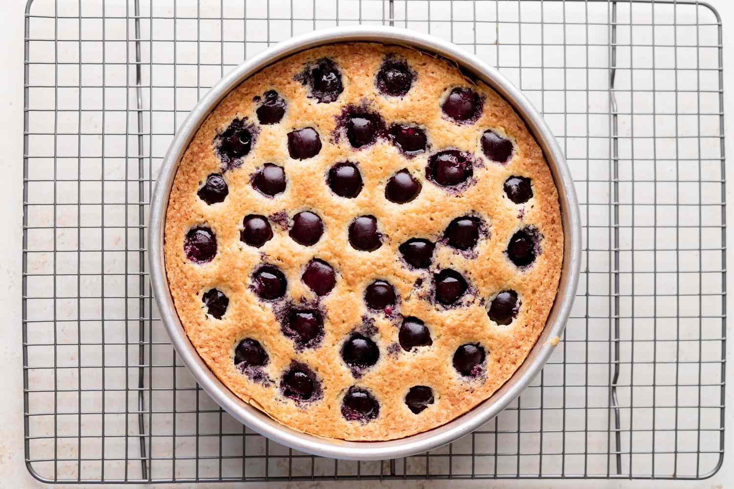 Cherry cake from scratch cooling on a wire rack.