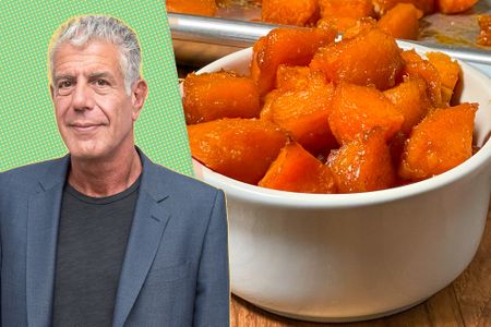 Anthony Bourdain next to a bowl of cooked potatoes