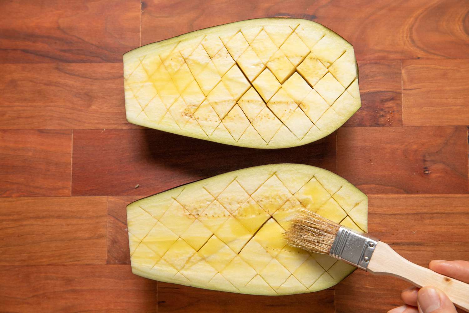 Olive Oil Brushed Onto Scored Eggplant Using a Pastry Brush for Roasted Eggplant Recipe