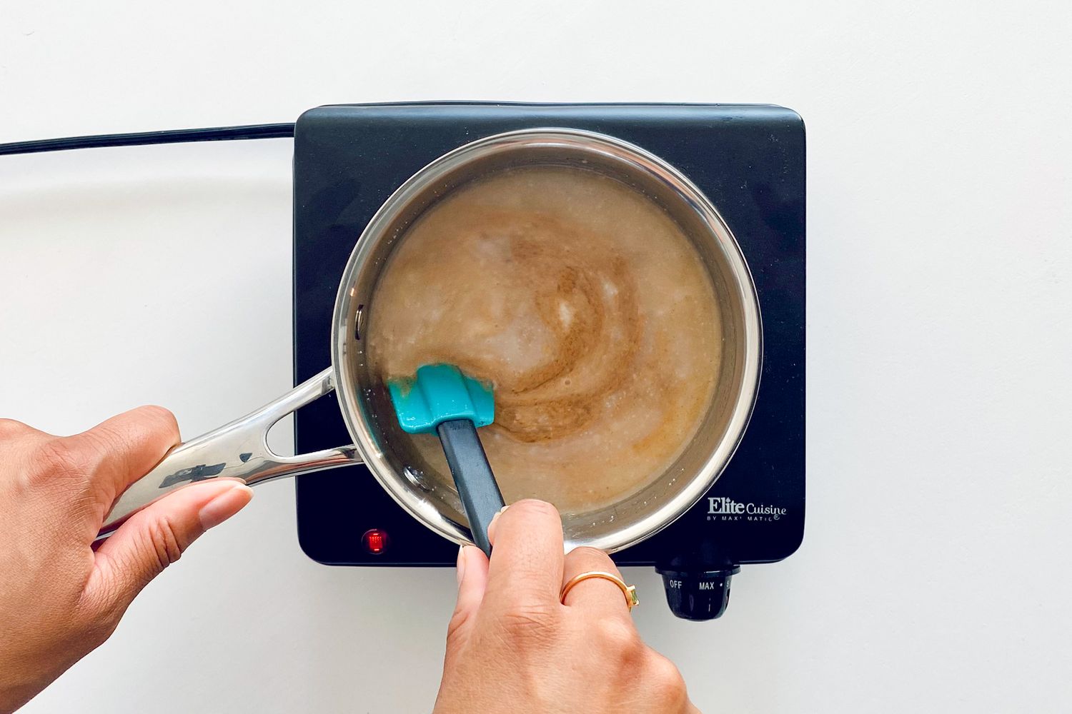 Warming syrup mixture to make Chewy Granola Bars with Dried Fruit and Nuts.