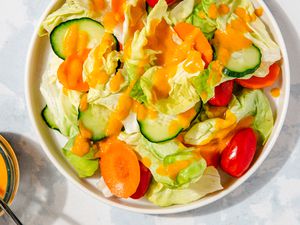 bowl of salad topped with carrot ginger dressing