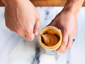 Stir natural peanut butter with a spoon