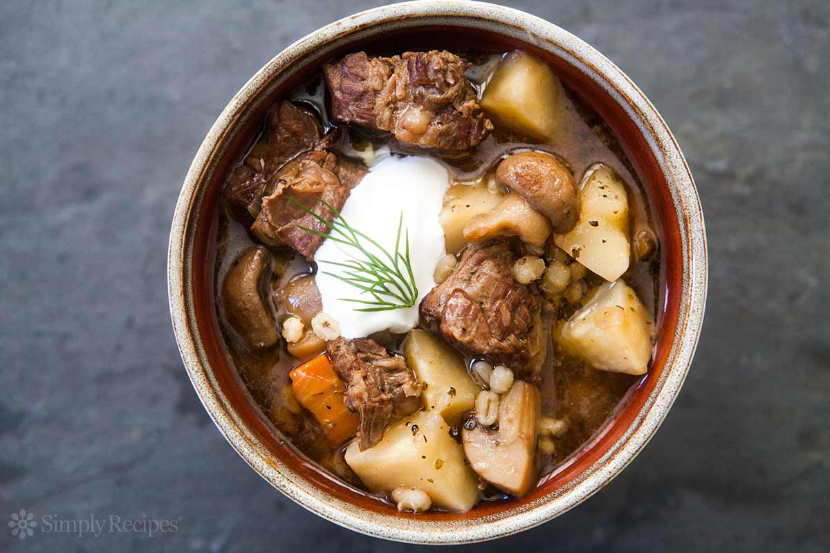 A bowl of beef and barley stew with mushrooms