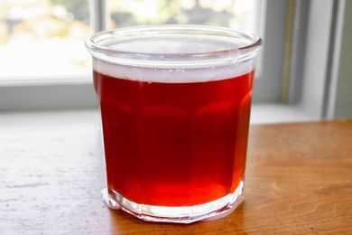 A jar of quince jelly glinting in the sun