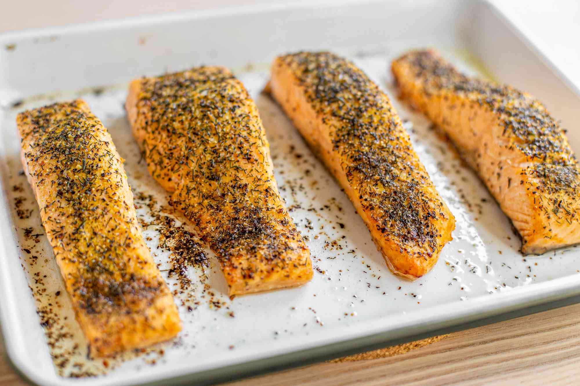 Lemon pepper and dill salmon on a white platter