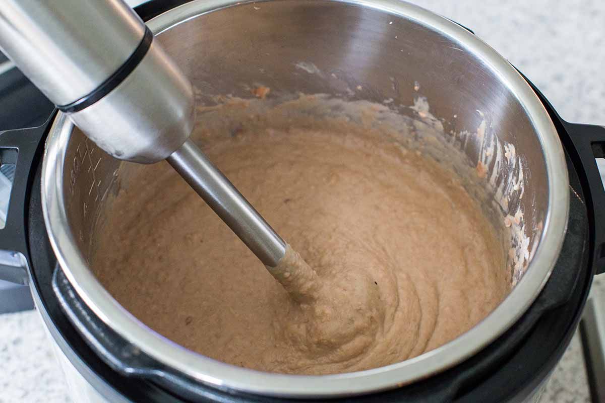 Using an immersion blender to make refried beans.
