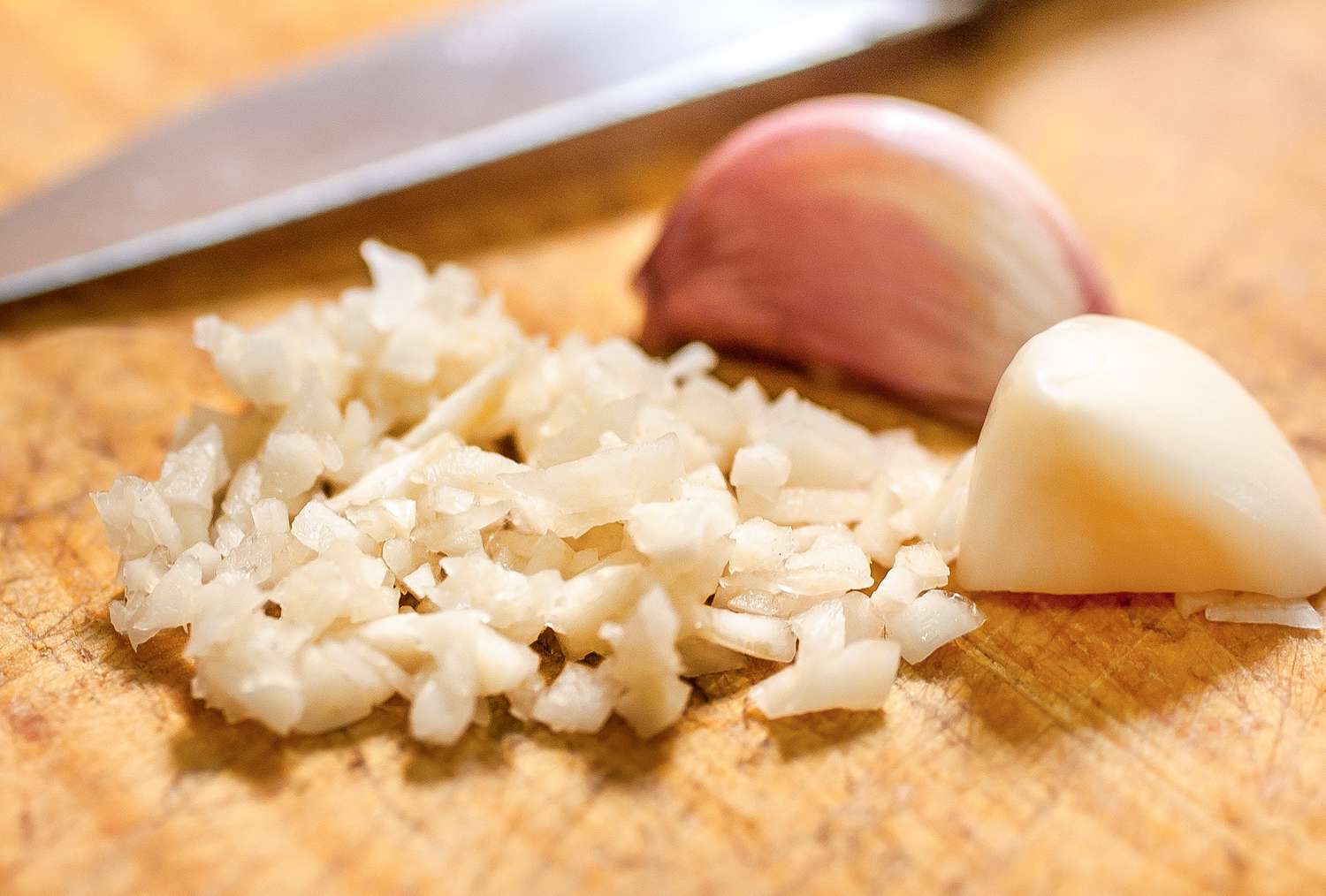 Garlic chopped on a wooden cutting board