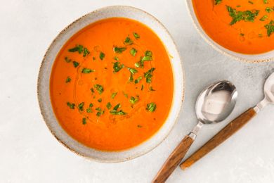 Pumpkin tomato soup garnished with herbs