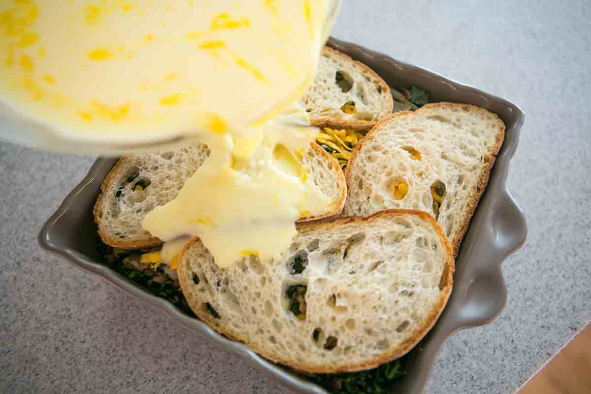 pour egg mixture over bread over kale mixture