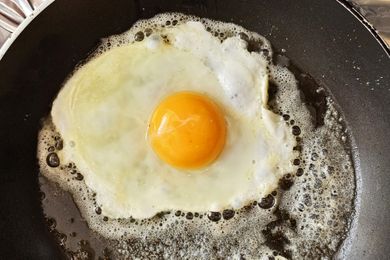 A fried egg cooking in a pan