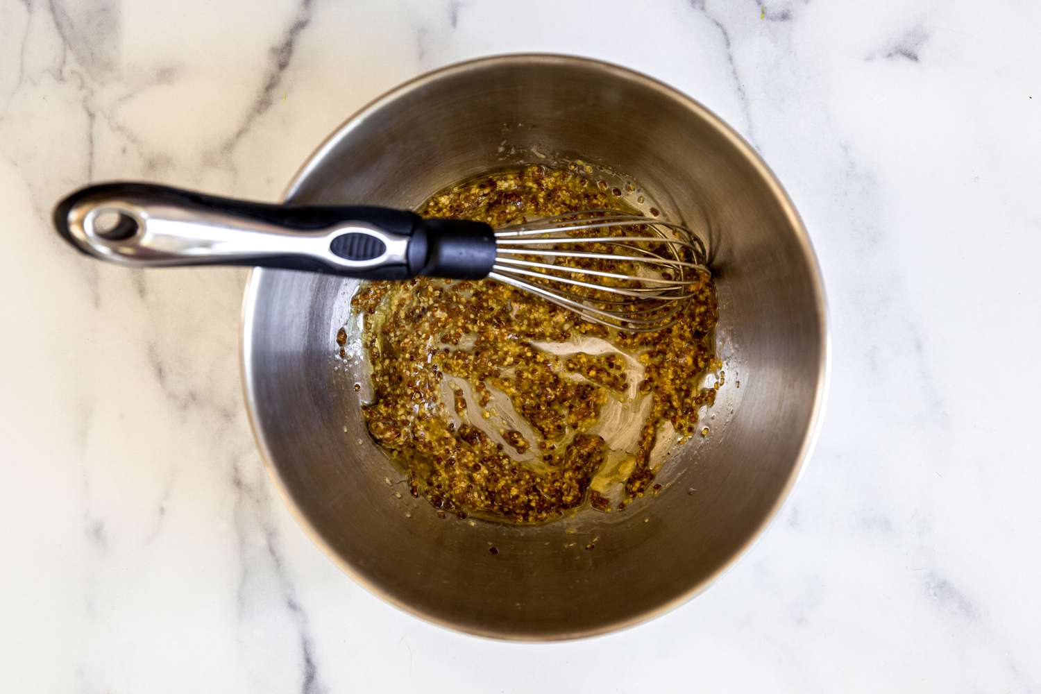 Whisking ingredients in a bowl to make mini barbecue meatloaves with broccoli and mustard glazed potatoes.