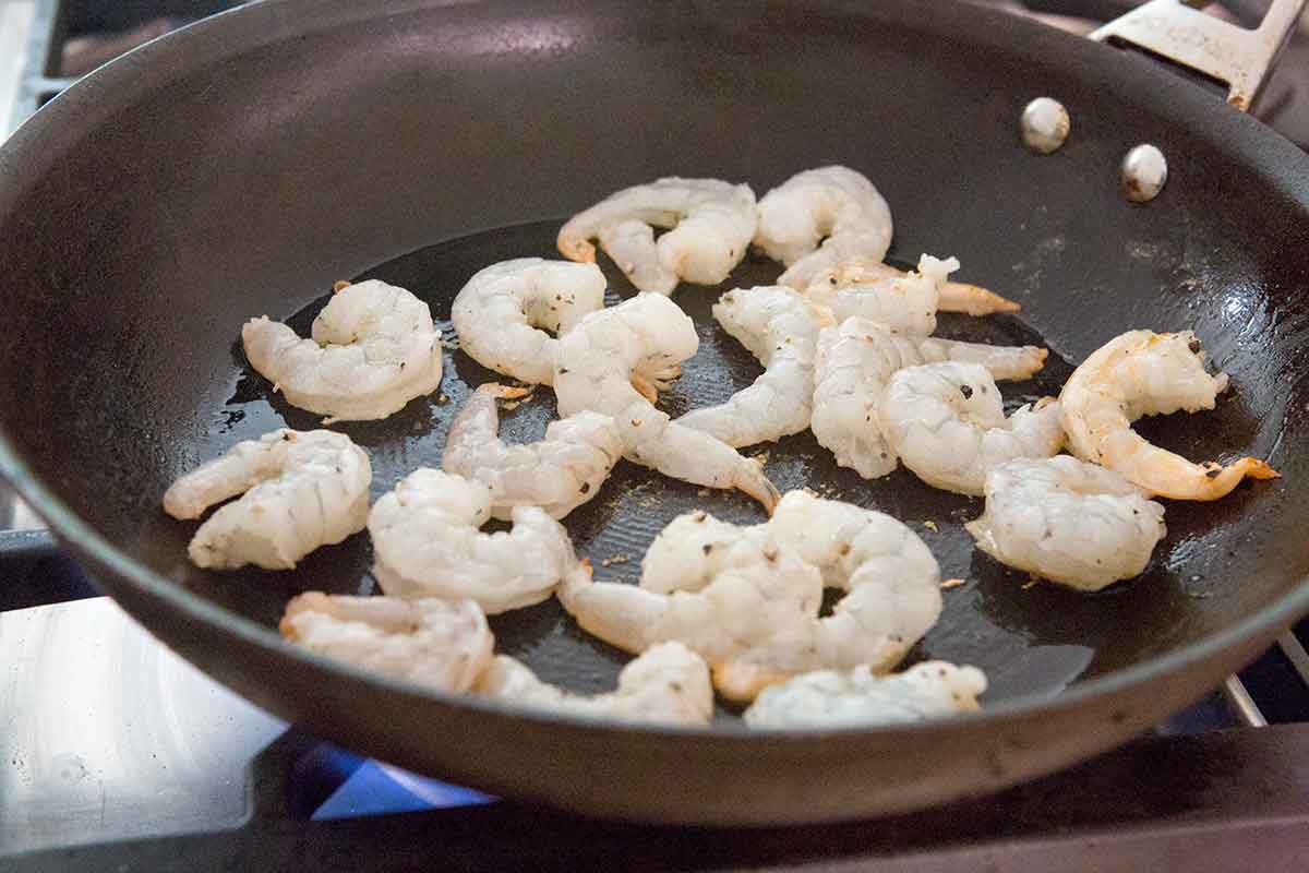Shrimp cooking in a pan on a stove