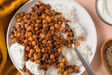 close-up of a plate of 20-Minute One-Pan Beef and Chickpeas with rice and greek yogurt