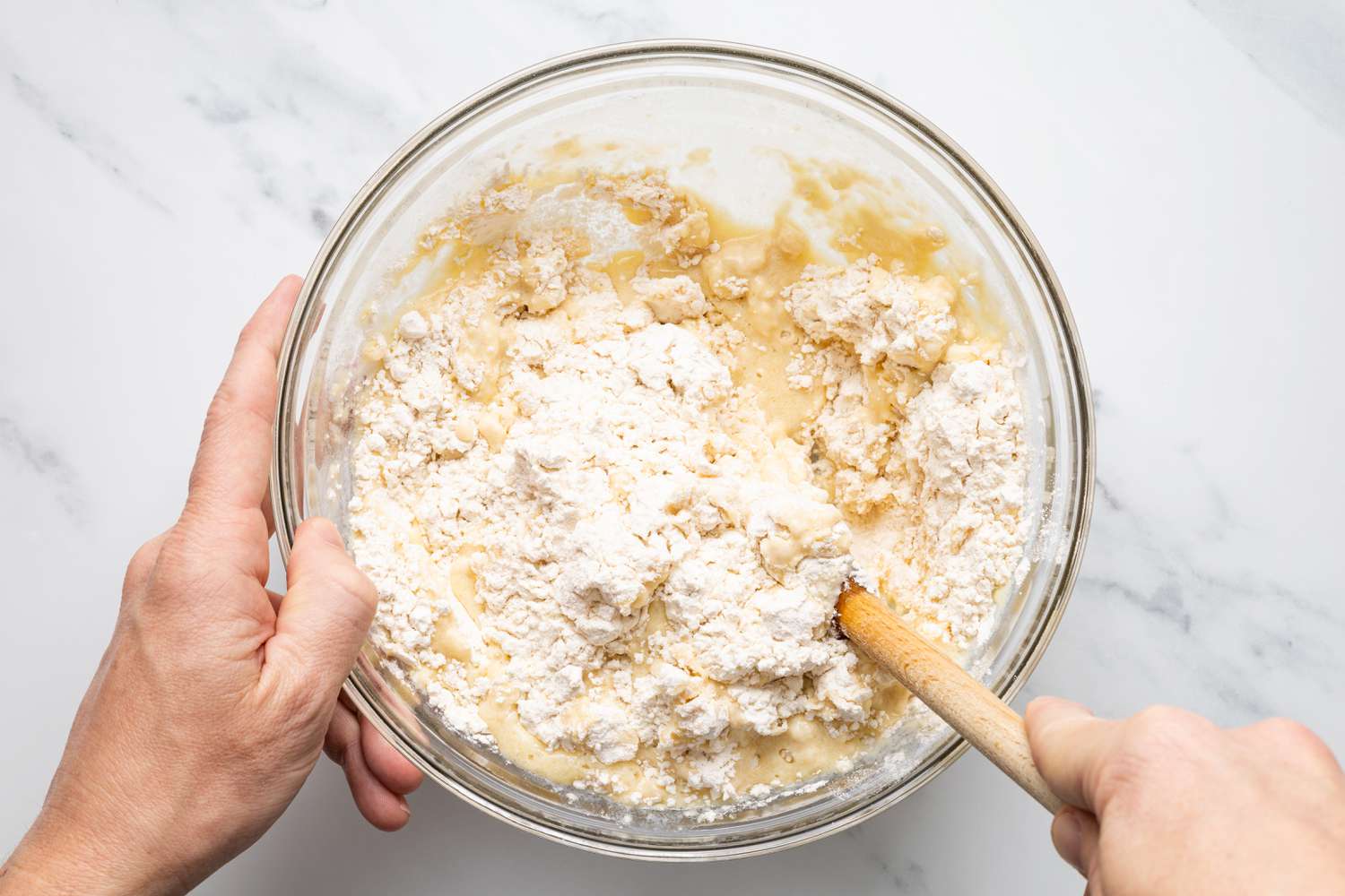 Bowl of Flour and Wet Ingredients Mixed Using Wooden Spoon for Pepperoni Rolls