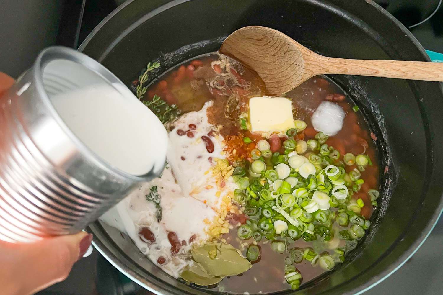 Add Coconut Milk to Beans in Dutch Oven for Jamaican Rice and Peas