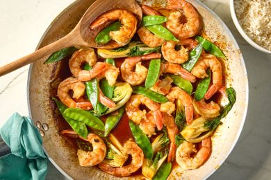 Shrimp Stir Fry in a wok with a wooden spoon