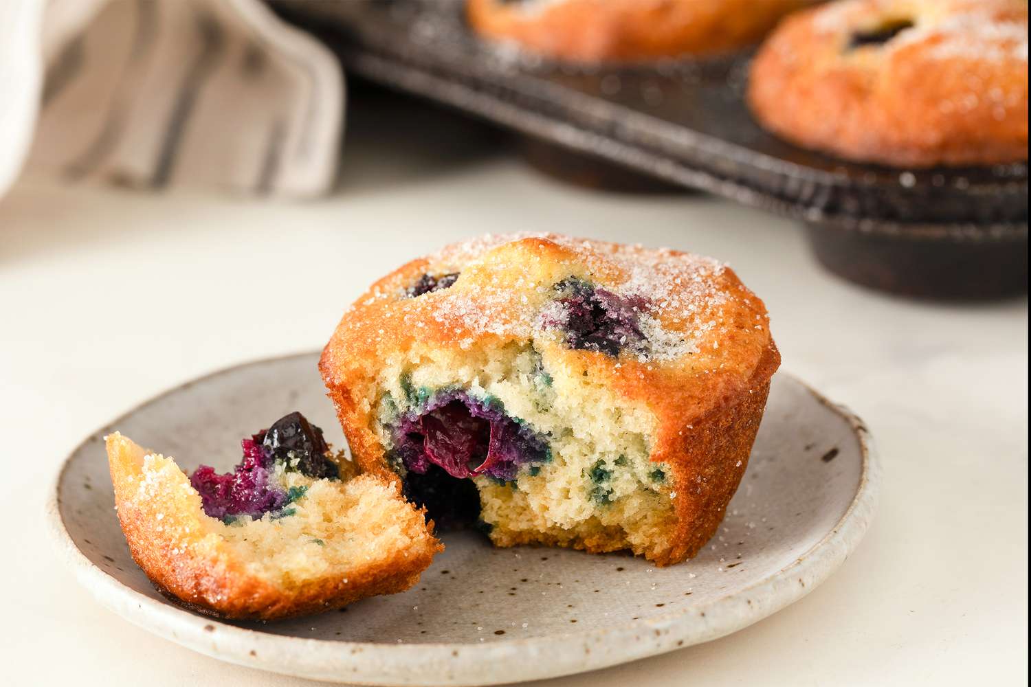 blueberry muffin, torn open and on a small plate