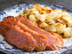 The best baked corned beef on a plate with some sauteed cabbage