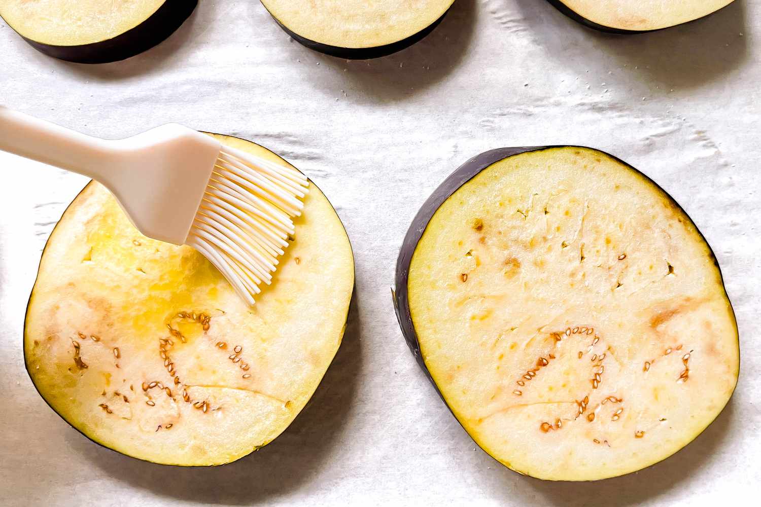 Olive Oil Brushed Onto Eggplant Slices Using a Pastry Brush 