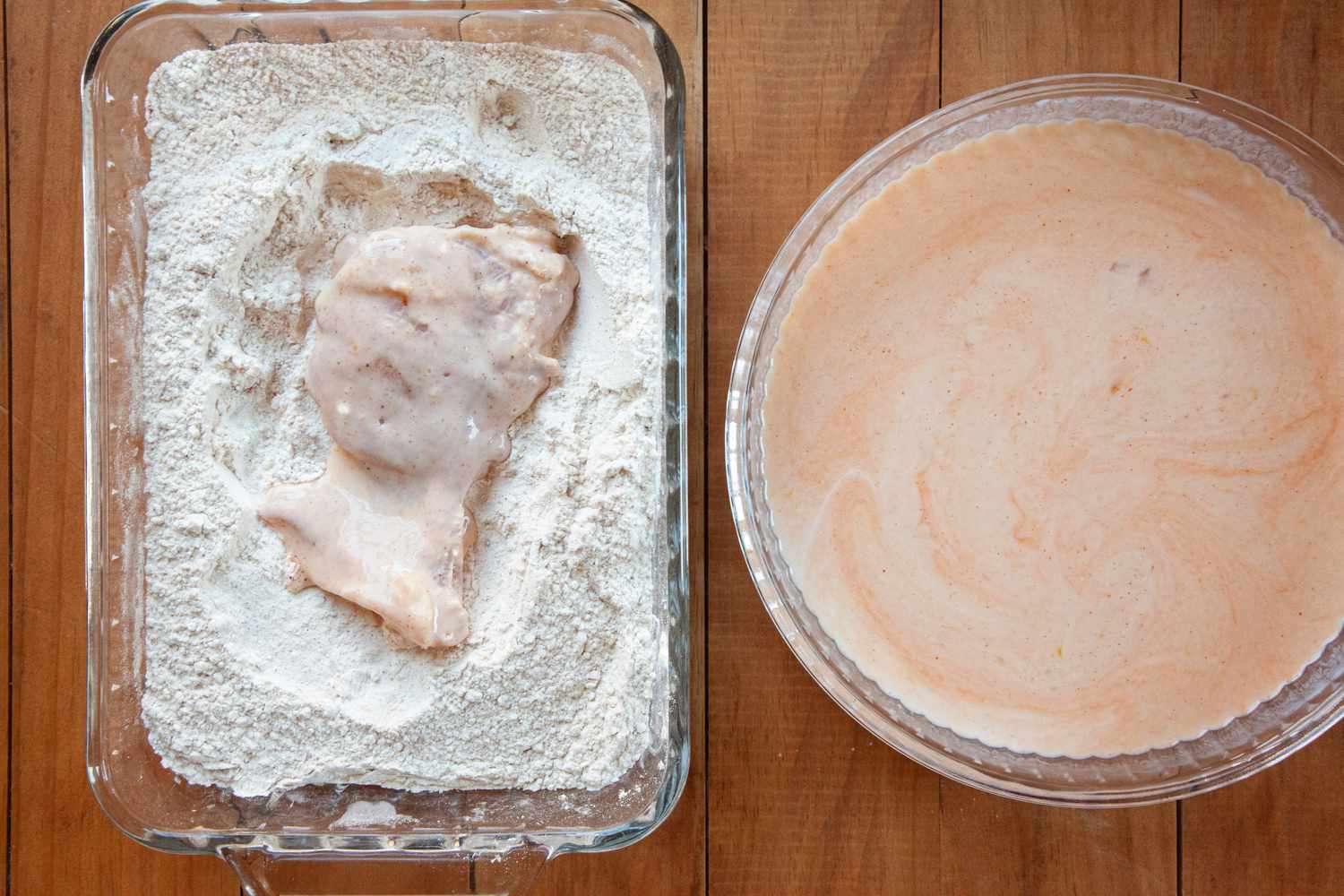 Breading a chicken thigh to make Nashville-style hot fried chicken.
