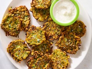 Plate of zucchini fritters with a side of dipping sauce