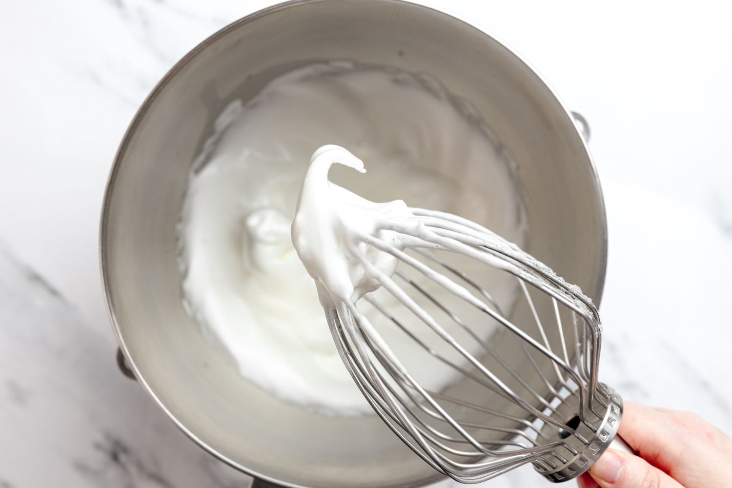 Meringue on a Stand Mixer Whisk Attachment and More Meringue in the Bowl Below 