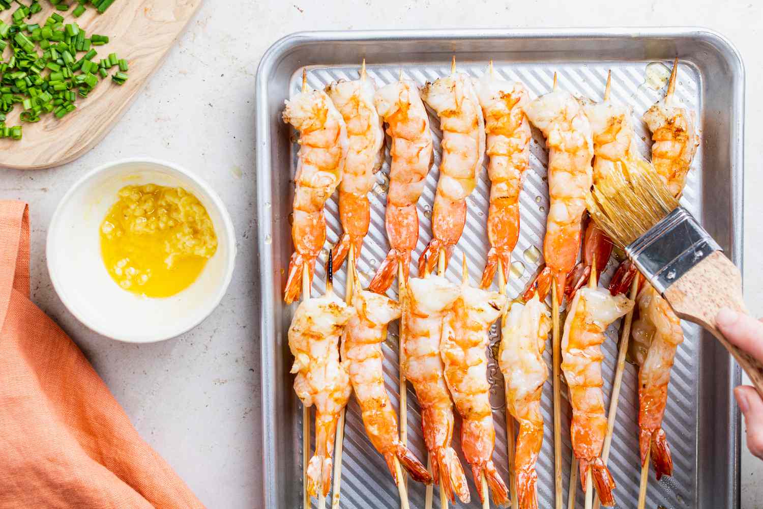 Overhead view of grilled garlic shrimp on a baking sheet.