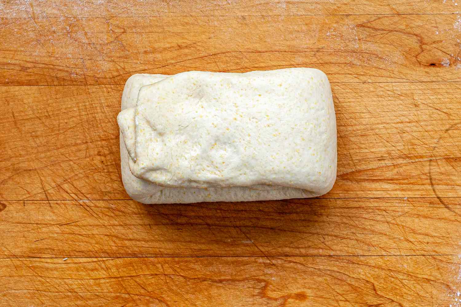 Italian Sausage Deep Dish Pizza dough folded into thirds.