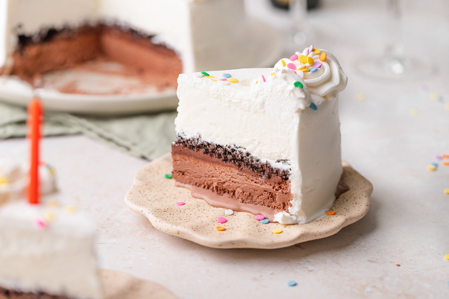 Slice of Ice Cream Cake on Plate with Rest of Cake in Background