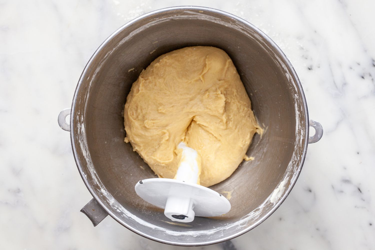 A dough hook mixing the dough for the ultimate brioche buns for hamburgers.