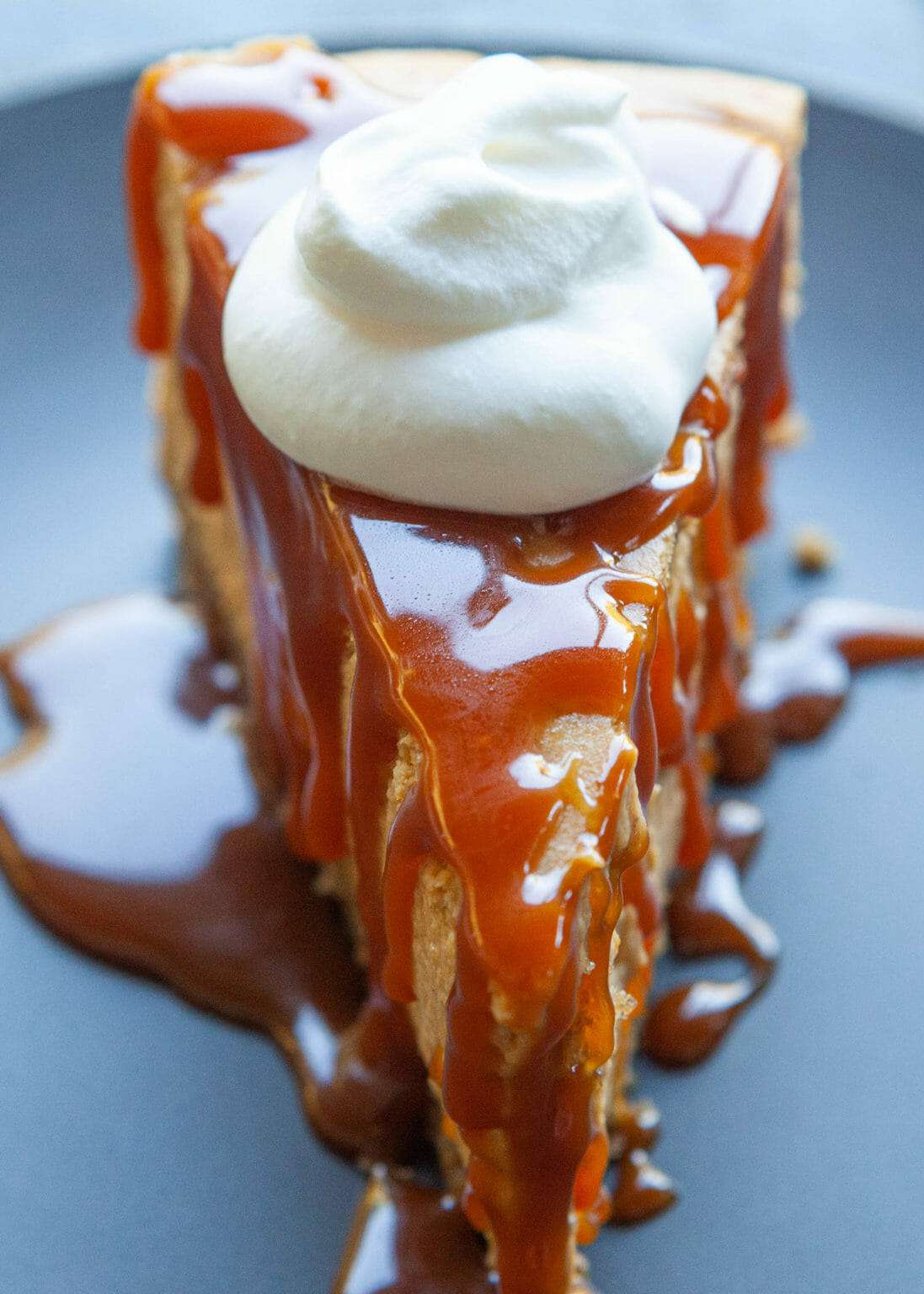 pumpkin cheesecake slice with caramel and whipped cream