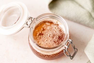 A small glass jar of brown butter sauce.
