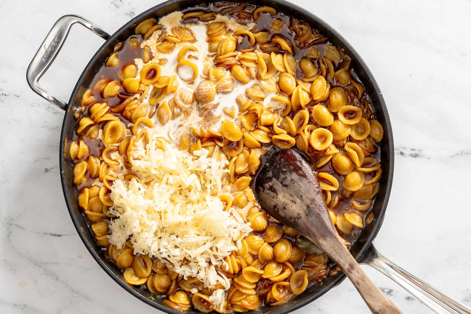 heavy cream and cheese added to the pot of French onion pasta