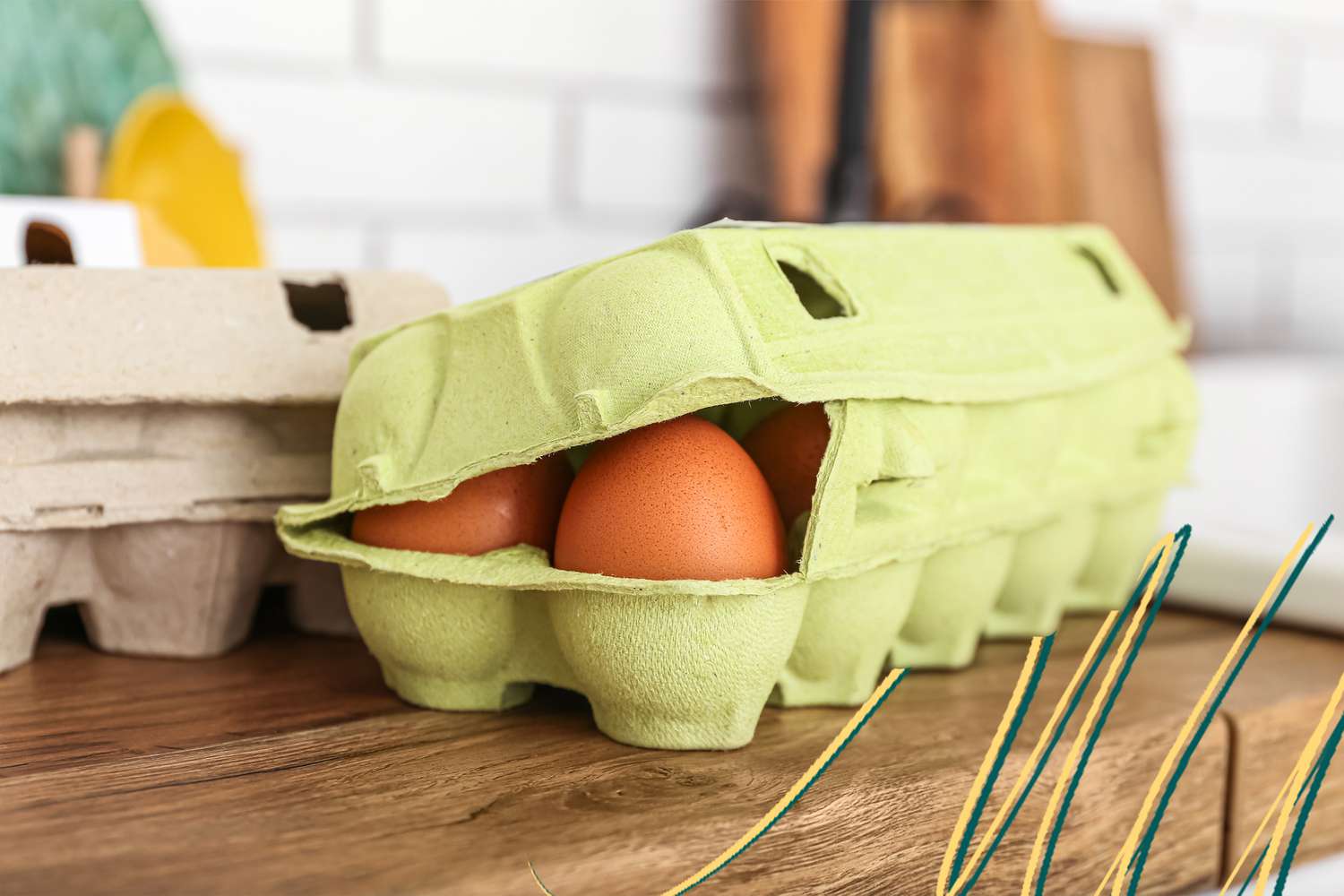 Carton of eggs on the counter and some blue and yellow lines in the lower right corner of the photo