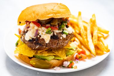 Nacho Mexican Burger with a side of fries.