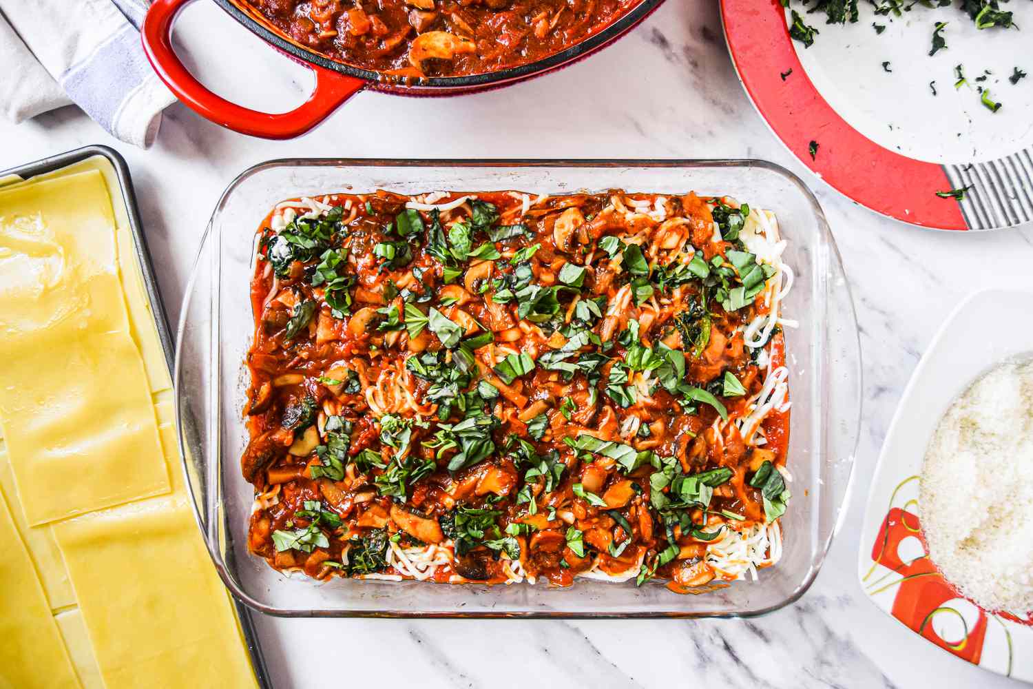 An additional Layer of Sauce and Spinach in a Casserole Dish for the lasagna 