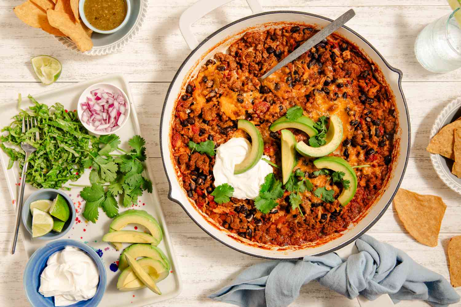 Cheesy Baked Taco Skillet with toppings on the side
